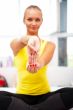 Portrait of beautiful young woman doing exercise at her home