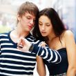 Portrait of young couple standing together at airport hall and l