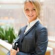Portrait of a cute business woman with her laptop inside office 