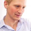 Closeup of a young business man sitting relaxed at his office ag