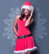 20-25 years od beautiful woman in christmas dress posing against