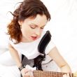 Portrait of beautiful young and attractive womanplaying her guit