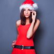 20-25 years od beautiful woman in christmas dress posing against