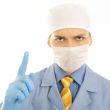 Closeup portrait of a serious young doctor pointing up