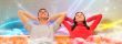 Smiling beautiful couple sitting on a sofa at their apartment an