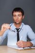 Portrait of an adult business man sitting in the office and sign