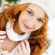 Portrait of young pretty woman in winter park