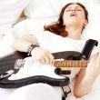 Teen girl holding a guitar like a rock star and enjoying playing
