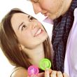 Portrait of young couple standing together and embracing and hol