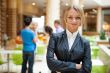 Portrait of a cute business woman with colleagues at the backgro