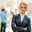 Portrait of a cute business woman with colleagues at the backgro