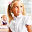 Portrait of a schoolgirl being in a classroom at school with her