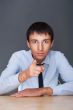 Portrait of aconfident young business man in suit pointing at yo