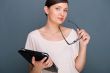 Portrait of young pretty woman holding tablet computer and glass