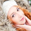 Portrait of pretty girl at winter background wearing warm clothe