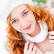 Portrait of beautiful young red hair woman outdoors in winter lo