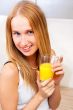Portrait of beautiful relaxed young woman standing at the kitche