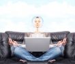 Portrait of young business woman sitting with a laptop on comfor