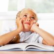 Portrait of a young girl in school at the desk.