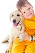 Handsome Young Boy Playing with His Dog Against White Background