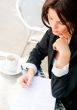 Closeup portrait of pretty woman sitting at cafe and signing doc