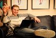 Happy young man  sitting on sofa at home
