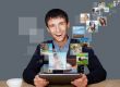 Portrait of young happy man sharing his photo and video files in