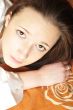 Closeup portrait of young pretty girl laying on her bed