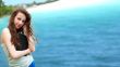 Beautiful brunette woman resting on the beach