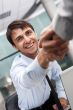 Closeup of business people shaking hands over a deal at office -
