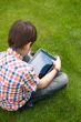 Young boy outdoors on the grass at backyard
