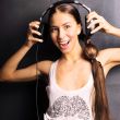 Club style woman with headphones listening to music