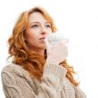 Portrait of beautiful red hair girl drinking coffee on winter ba
