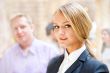 Portrait of a cute business woman with colleagues at the backgro