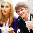 Closeup portrait of an attractive young couple eating fruit sala