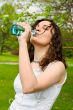 Young woman drinking water at outdoors