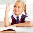Image of smart child reading interesting book in classroom. Hori