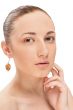 Portrait of a beautiful woman up-close and wearing an earing