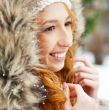 Portrait of pretty girl at winter background wearing warm clothe