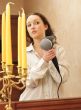 Beautiful woman drying her hair with hairdryer