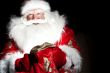 Santa sitting at the Christmas room and looking into the sack