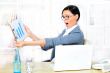 Beautiful business woman smiling while working with reports and 