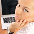 Young business woman on a laptop from behind