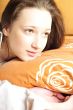 Closeup portrait of young pretty girl laying on her bed