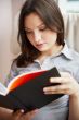 Young sexy woman at home reading book 