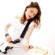 Portrait of beautiful young and attractive womanplaying her guit