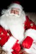 Santa sitting with a sack indoor at dark night room