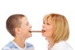 Portrait of happy european family of son and his mother eating c