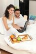 Couple enjoying breakfast in bed