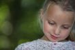 little blonde girl watching down look amused
